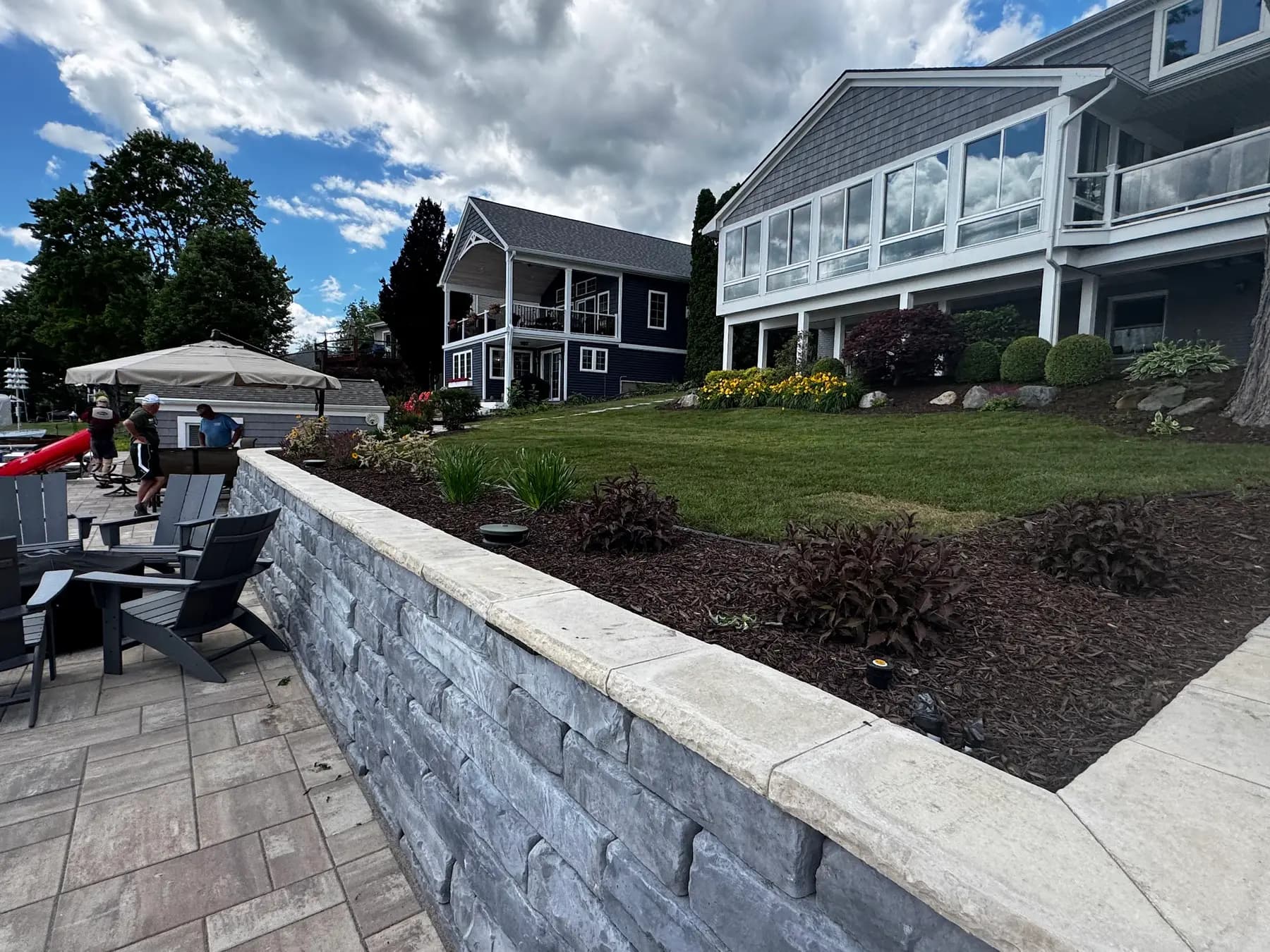 Block retaining wall edging a paver patio