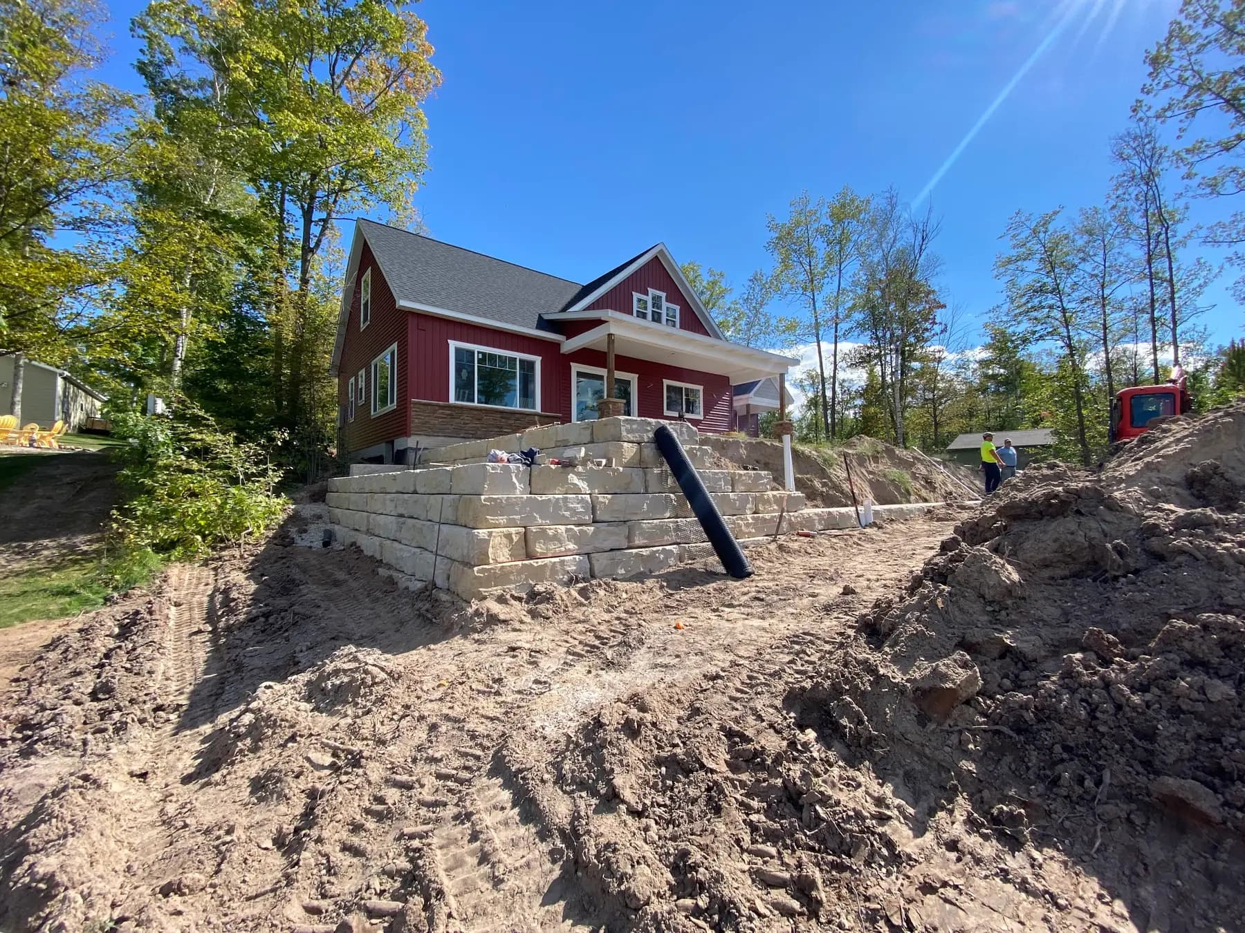 Block retaining wall being built into a slope
