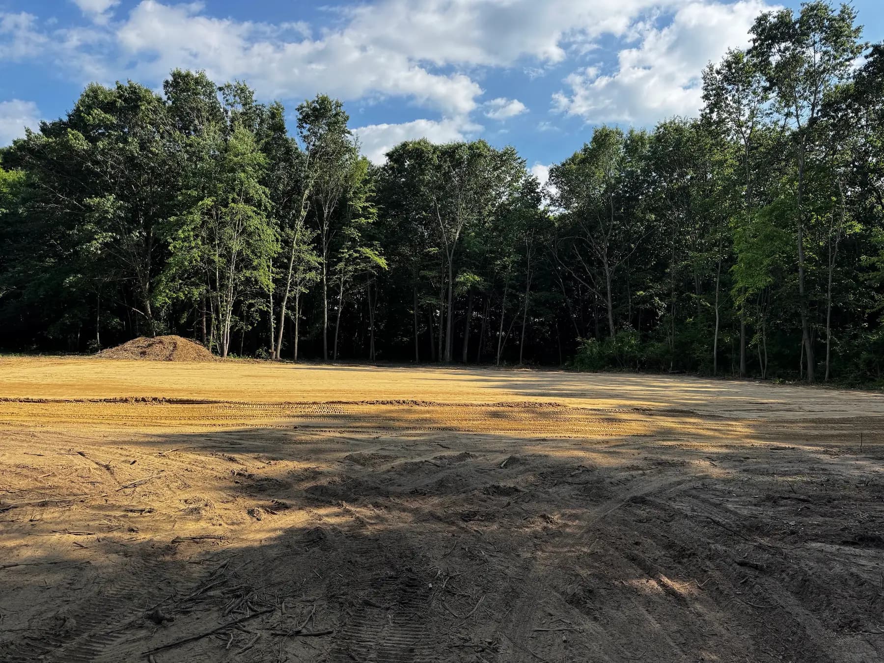 Dirt lot cleared and rough-graded, ready for the next phase of the build