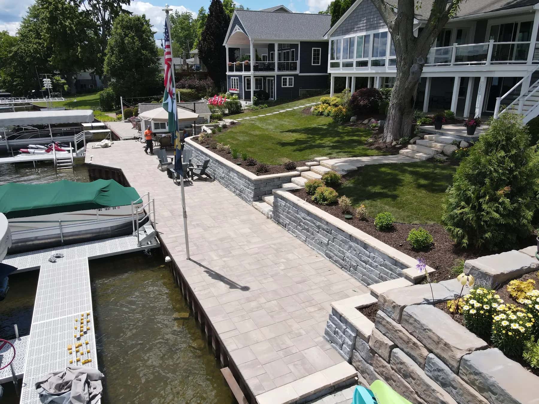 Stone retaining walls and steps along a landscaped waterfront property