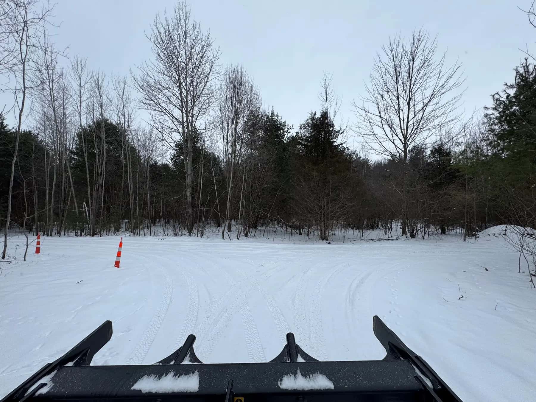 View from the Onyx track loader across a snow-covered lot in winter